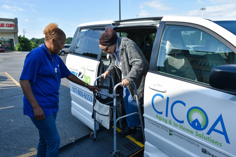 Older woman getting out of a CICOA Way2Go Transportation Van
