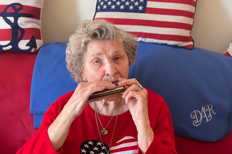 Mildred playing the harmonica