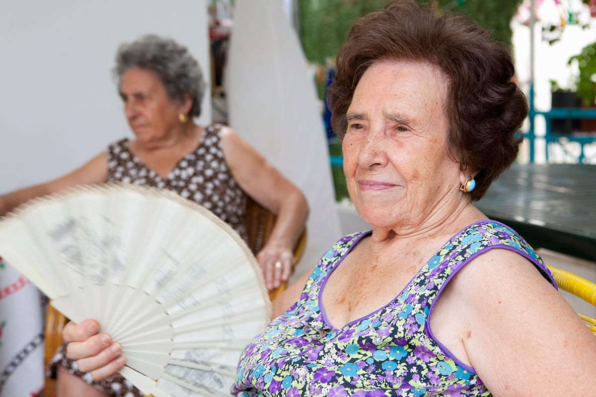 Older women trying to stay cool in hot summer temperatures