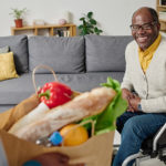 Senior man receiving healthy groceries at home