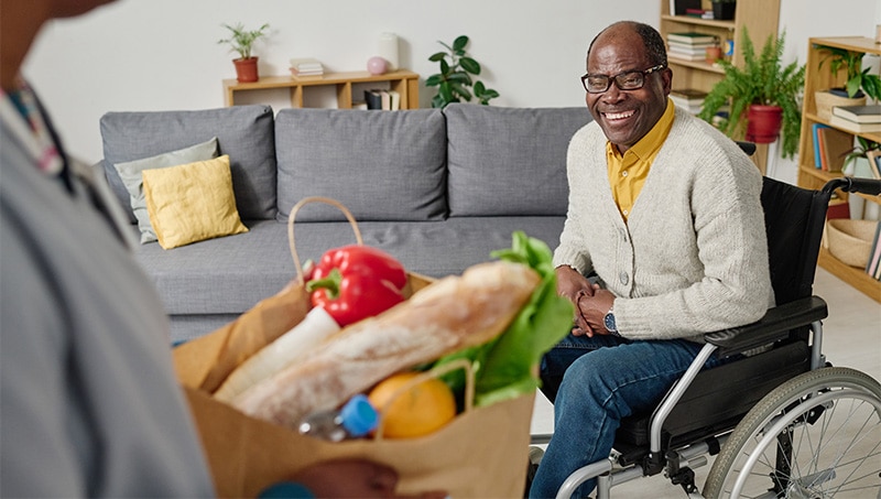 Senior man receiving healthy groceries at home