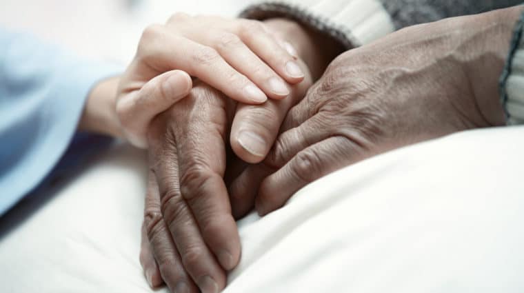 Caring Hands Holding a Patient's Hands