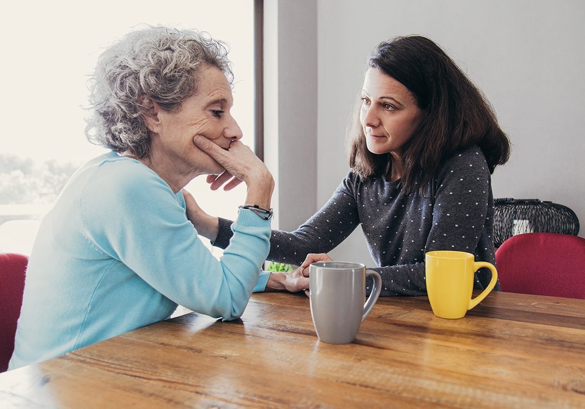 Daughter Having Serious Conversation with Senior Mother