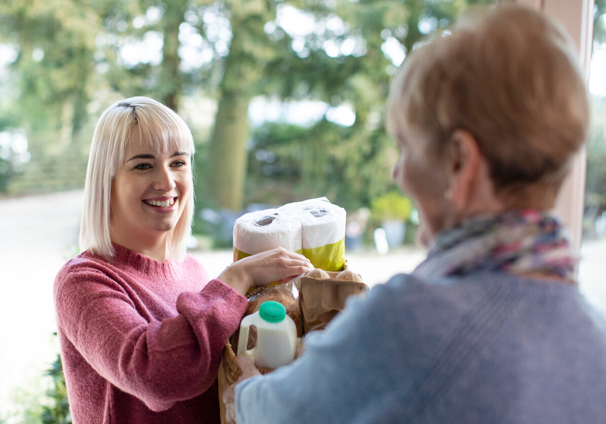 Daughter Bringing Groceries to Older Mom