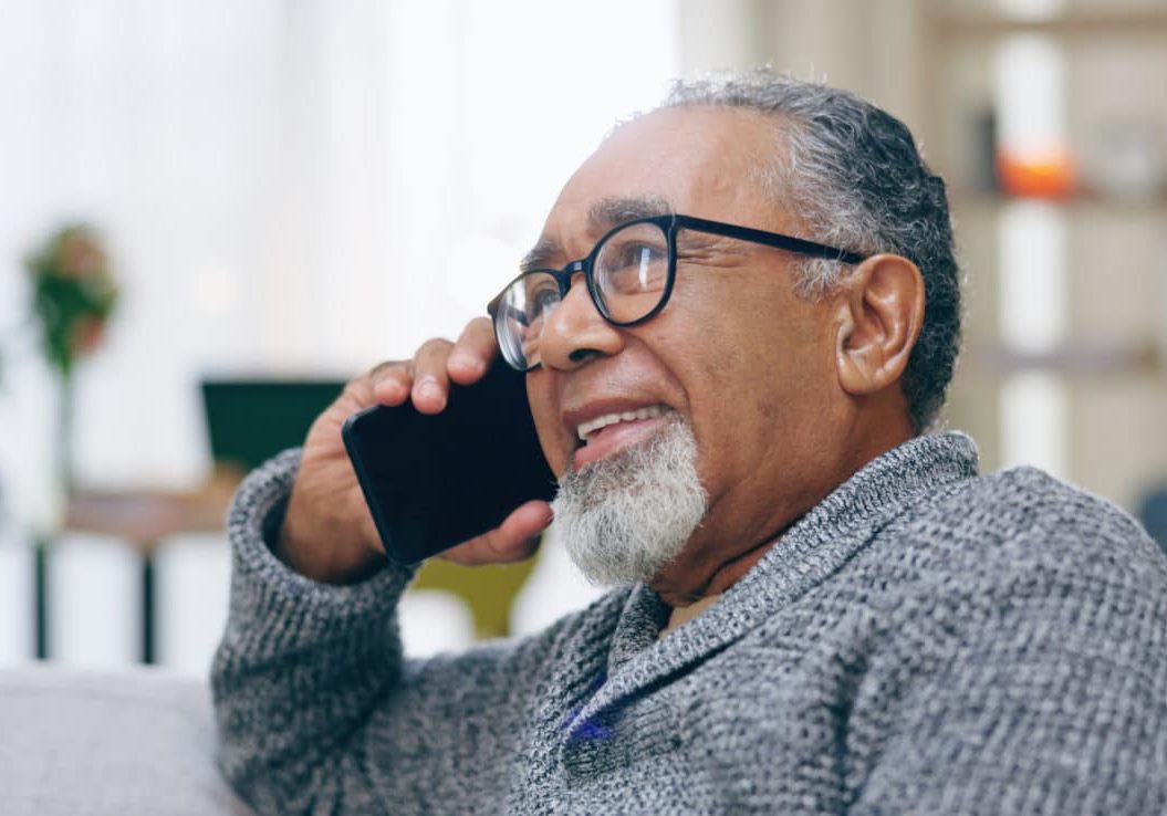 Senior Man, Happy And Phone Call On Sofa With Thinking, Talking And Contact In Home Living Room. Elderly Person, Smartphone And Smile For Communication, Conversation Or Relax On Lounge Couch In House Senior man on the phone