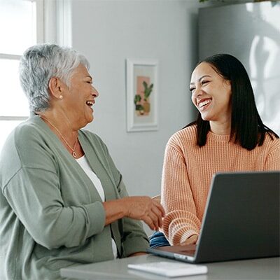 Hispanic senior woman and a care manager in her home